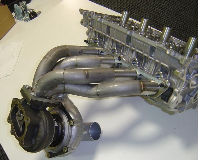 Fig 2 - Exhaust manifold & turbo. Note how the manifold tapers to